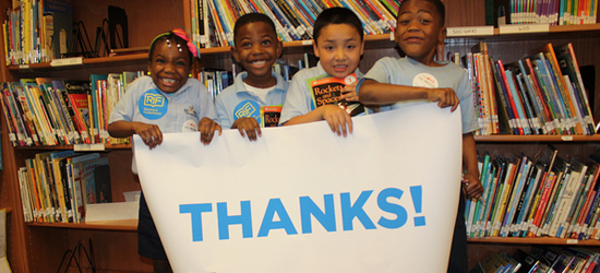 Kids holding up 'Thanks' sign