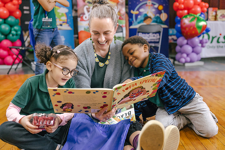 Teacher reading a book to kids