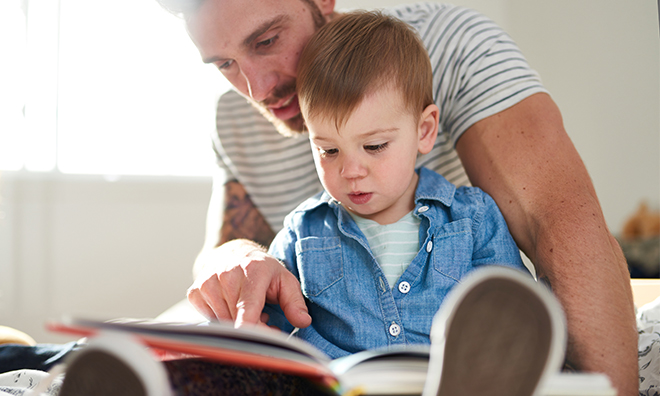 Photo of dad and child reading