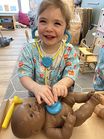 Happy girl in dramatic play center