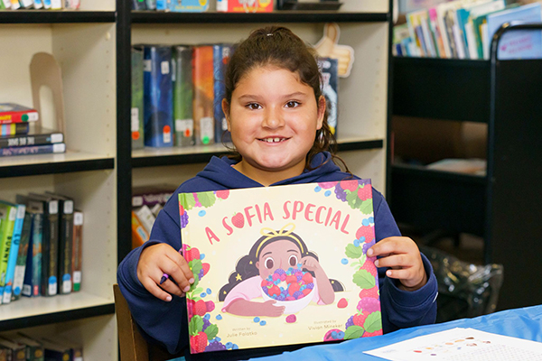Child holding A Sofia Special book