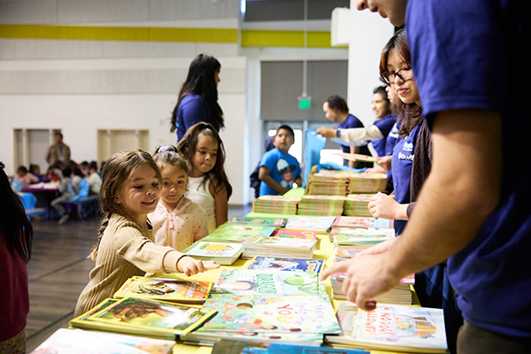 Children selecting books at an event
