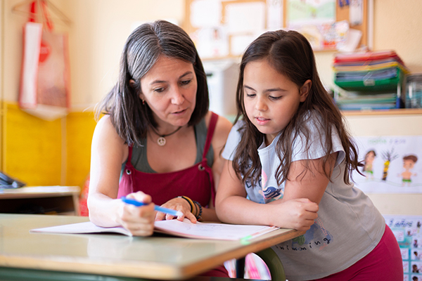 Adult and child reading together