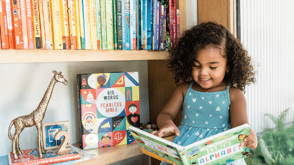 child happily reading a book
