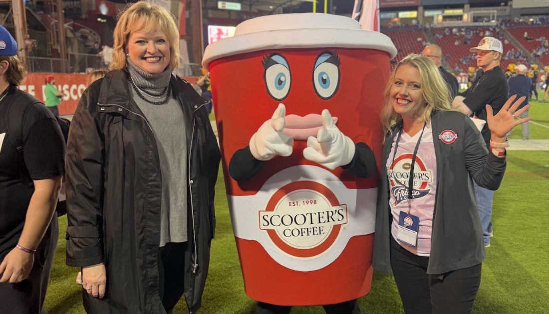 Alicia Levi standing with Scooter's Coffee mascot