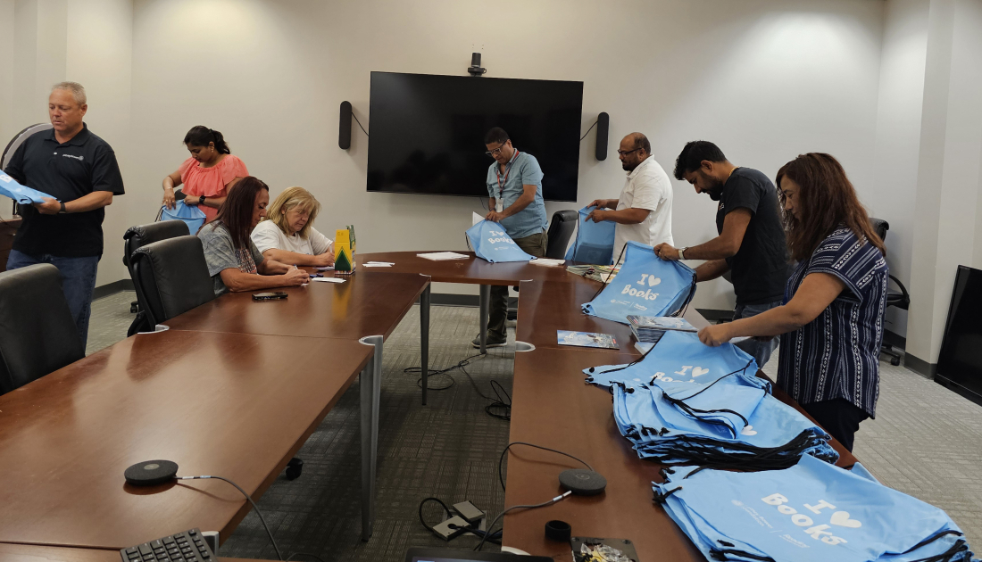 Employees assembling literacy kits
