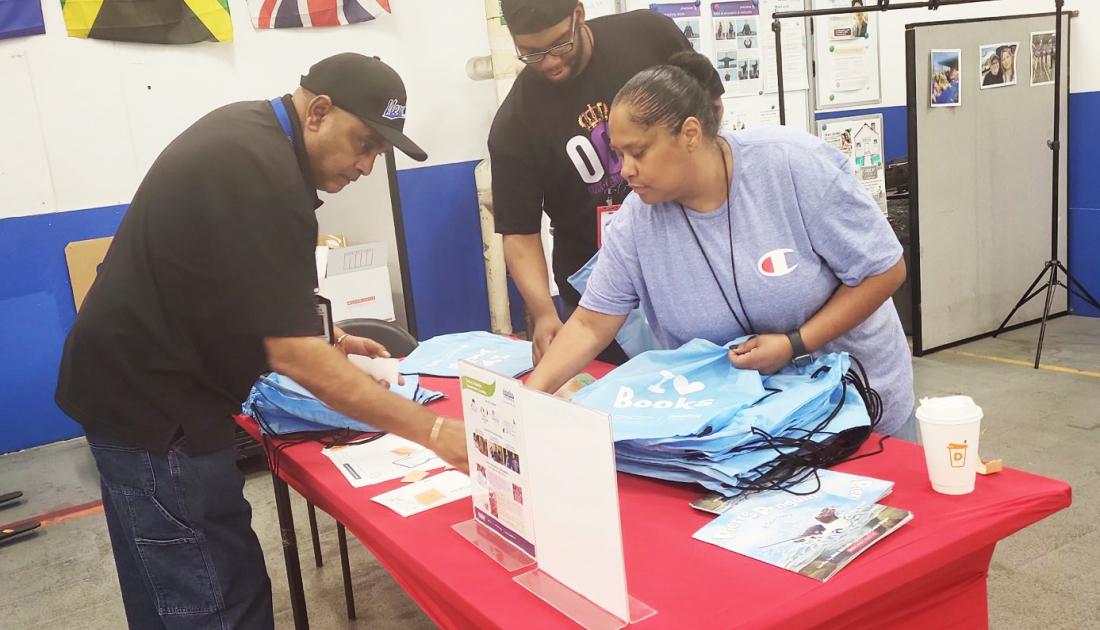 Employees putting together literacy kits