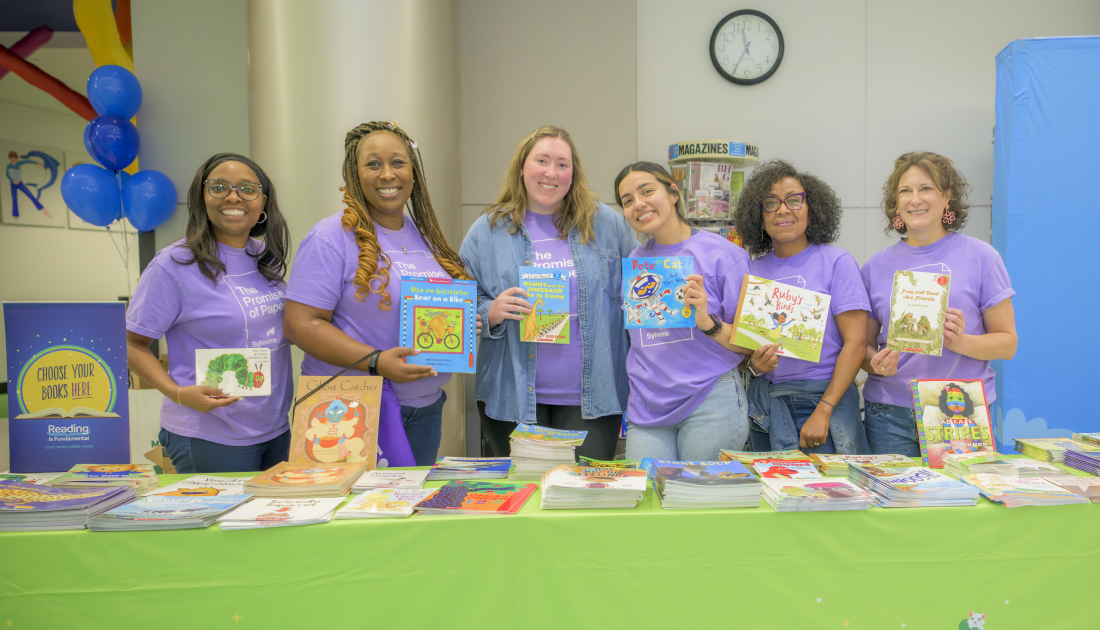 staff posing in front of books