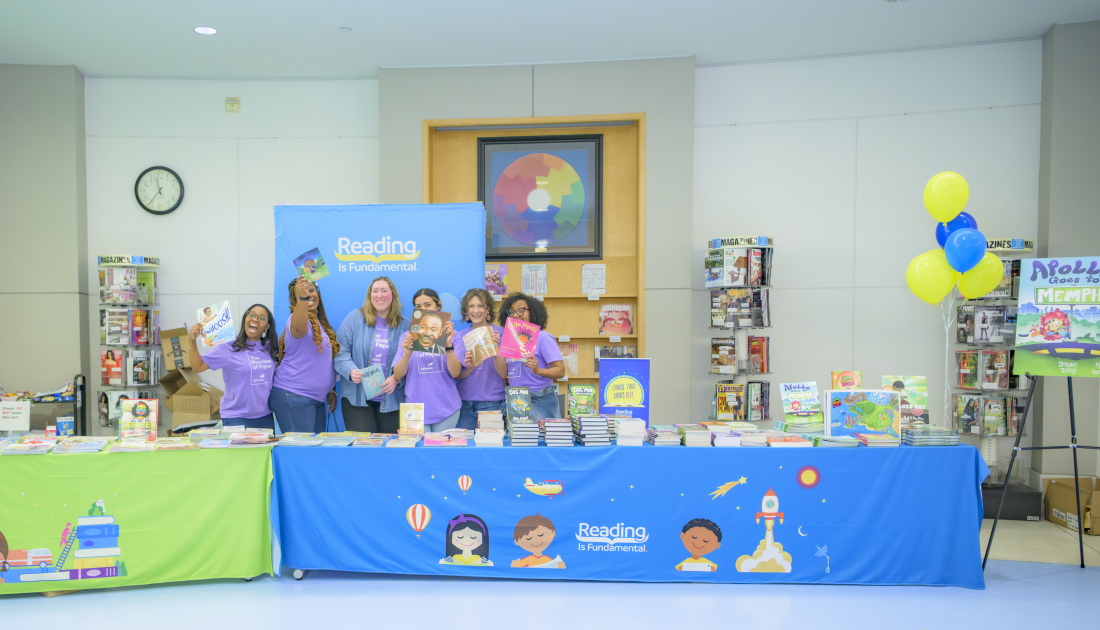 staff posing in front of books