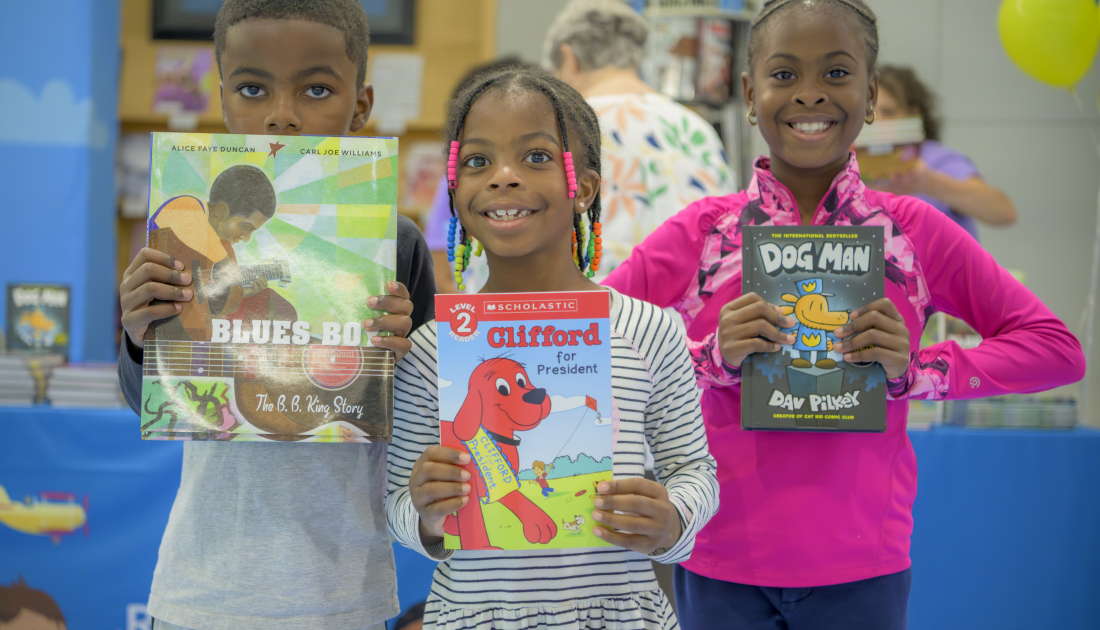 children posing with books