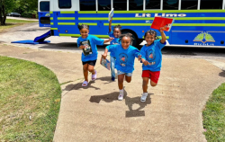 Kids running with books from the Lit Limo Bus