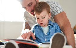 Photo of dad and child reading
