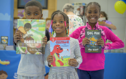 children posing with books