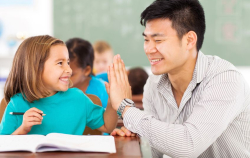 Young student giving a high five to her teacher