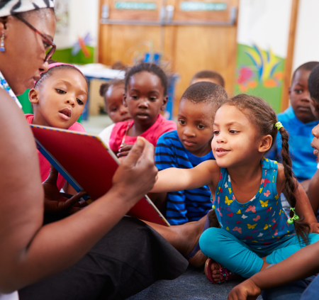 Teacher reading to young children in classroom