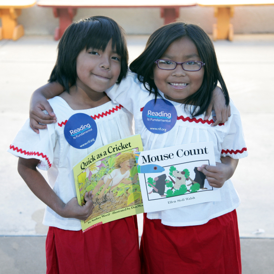2 girls smiling holding their books friendship reading