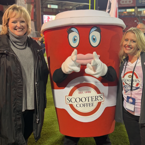 Alicia Levi standing with Scooter's Coffee mascot