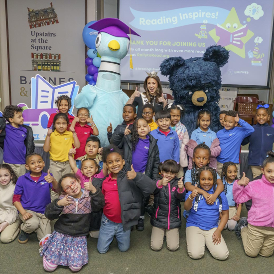 Pigeon and bear mascots posing with children