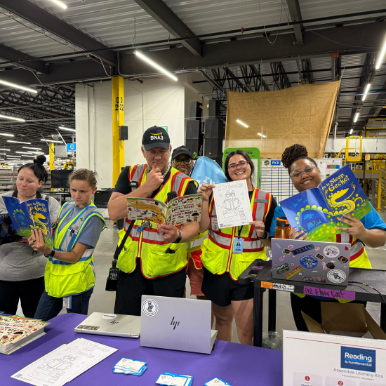 Amazon volunteers during a literacy kit event