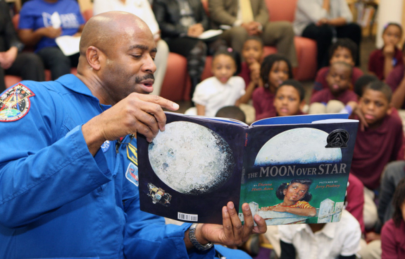 astronaut reading book aloud at RIF event