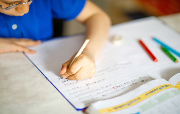 Child writing on notebook