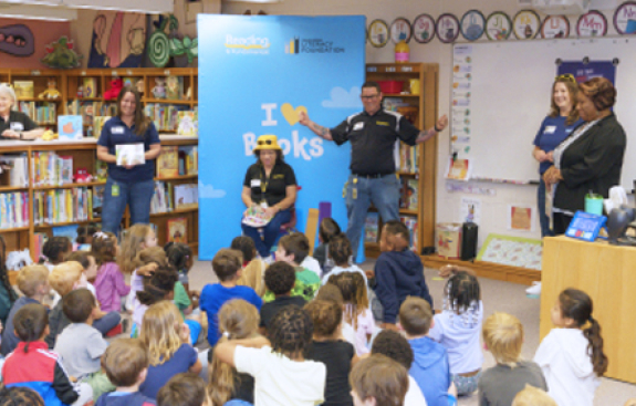 Image of adults reading to children