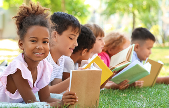 Group of kids reading outside