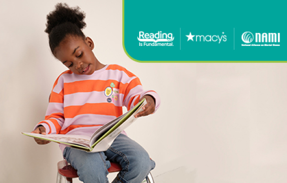 Image of child reading a book happily