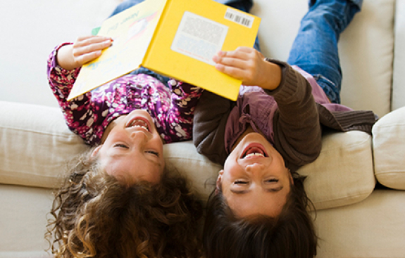 Two kids reading a book together