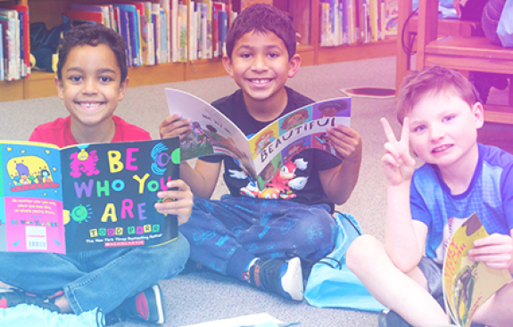 Kids smiling and reading books