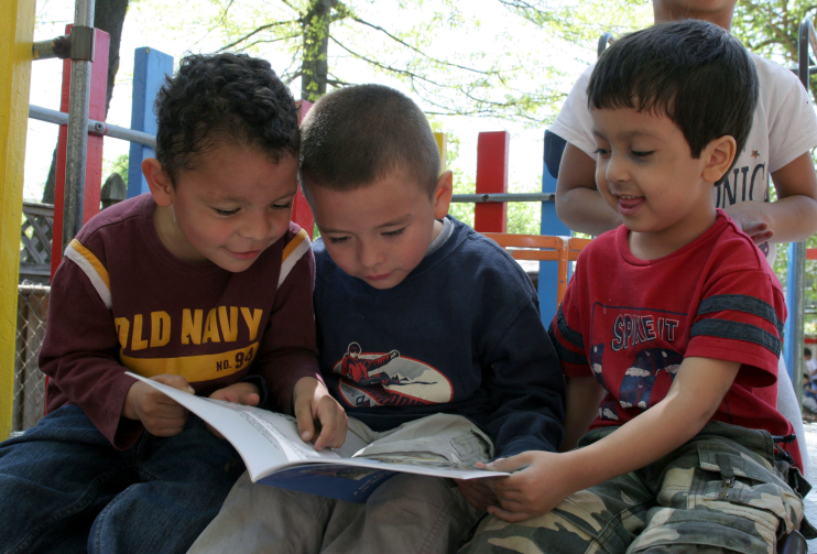 3 boys outside reading books