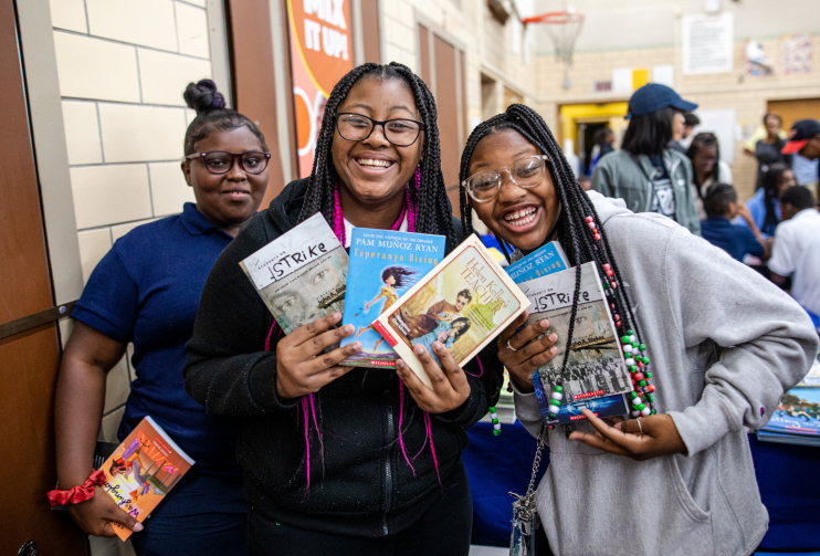 Teen girls smiling with books