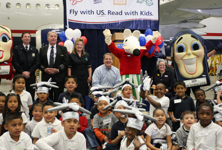 In 2008, US Airways CEO Doug Parker and RIF President and CEO Carol Rasco pose with children at the "Fly with US. Read with Kids." kick-off in Phoenix.