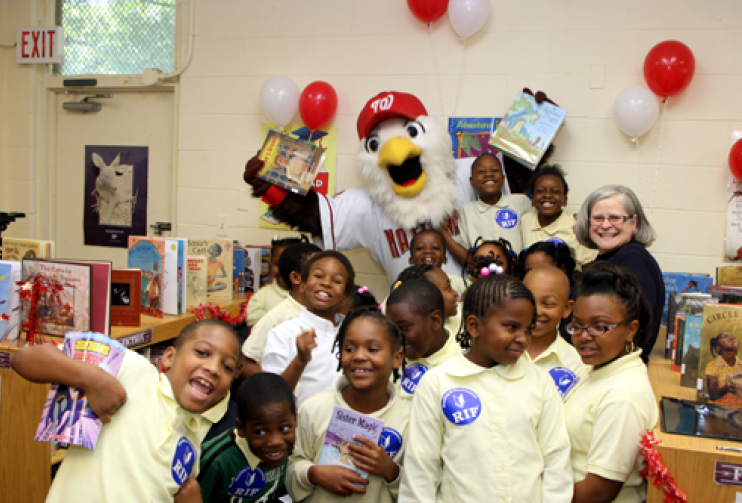 From 2009: Carol Rasco with RIF kids at Kimball Elementary School (DC) and Screech, the Washington Nationals mascot.