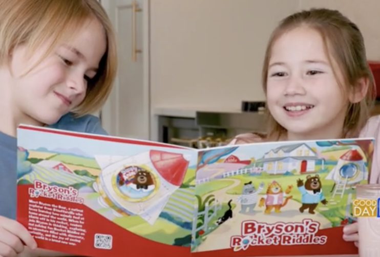 Two kids reading Stauffer's book