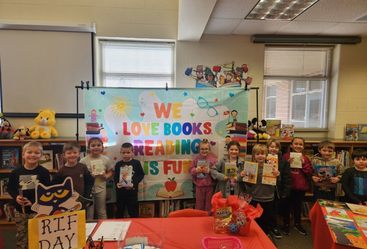 Children posing with books