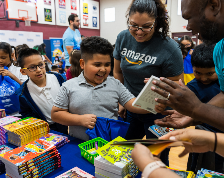 Children and smiling boy at Amazon RIF book event