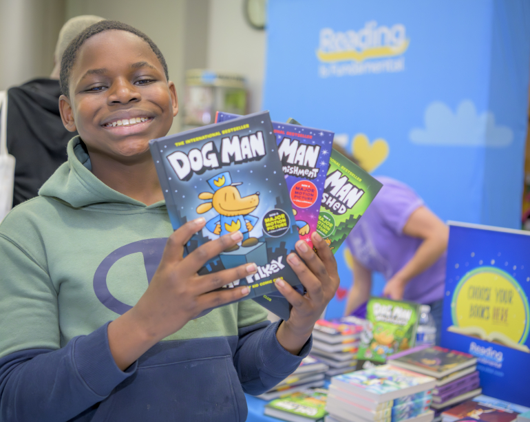 boy smiling with books