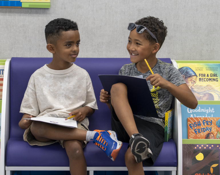 Two boys reading together