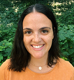 Karly O'Brien smiles at the camera while outdoors. She is the Content Developer for Reading is Fundamental.