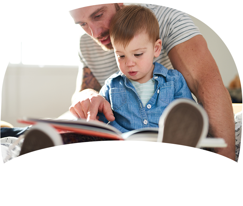 little boy reading with dad