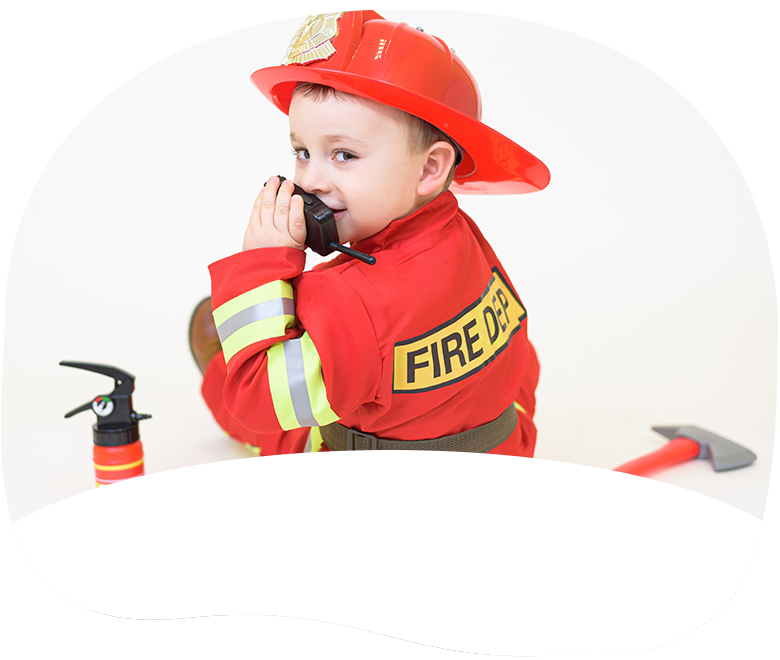 Toddler in firefighter speaking into radio