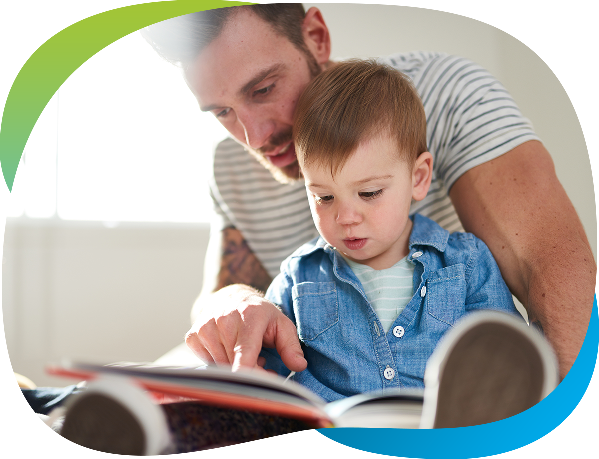 little boy reading with dad