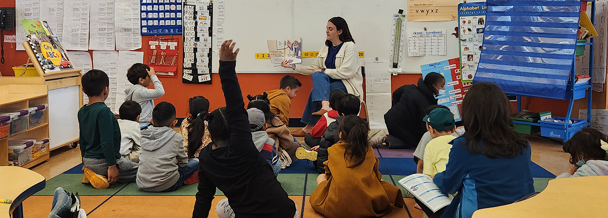 RIF staff reading a book aloud to children
