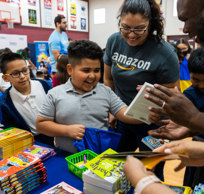 Children and smiling boy at Amazon RIF book event