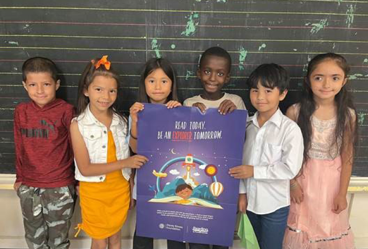 Kids holding a poster together
